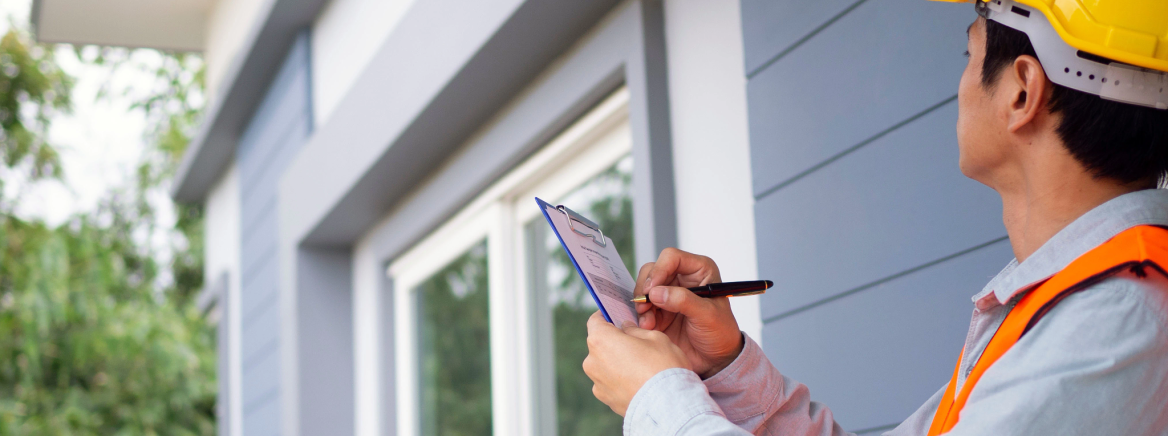 Photo of a home inspector examining a property.