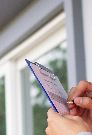 Photo of a home inspector examining a property.